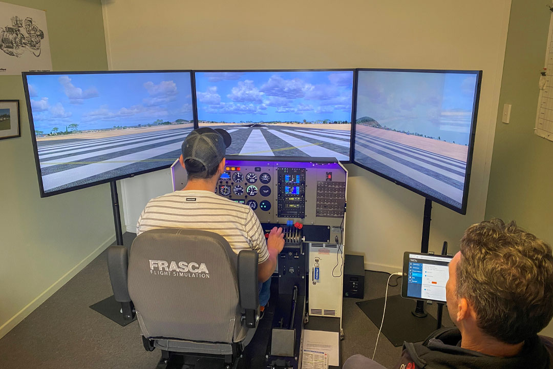 Student using the Frasca flight simulator